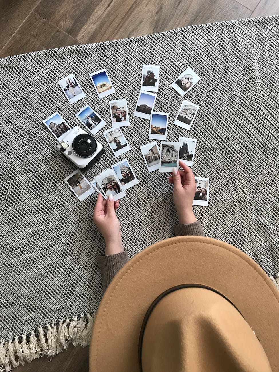 person holding instant pictures